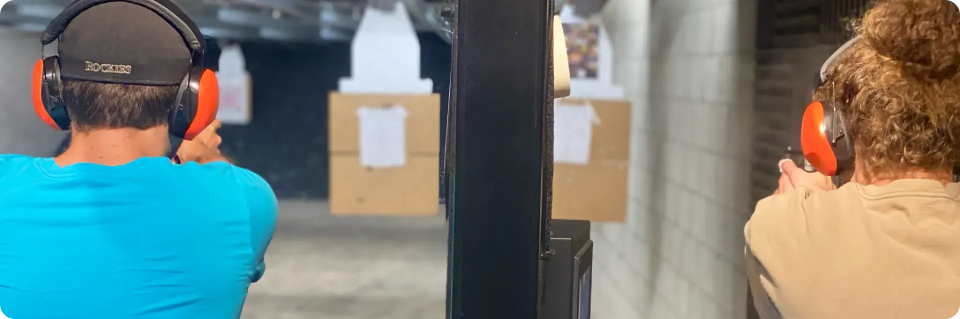 Instructor providing hands-on firearms training to student