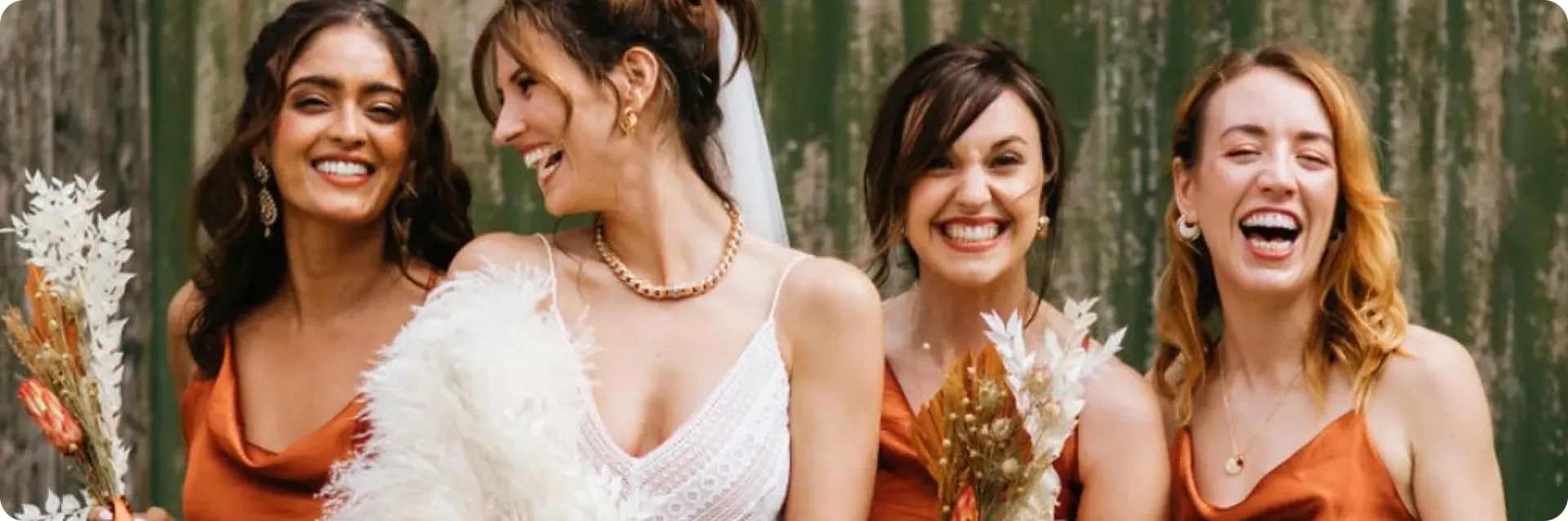 A bride and her bridal party laughing together