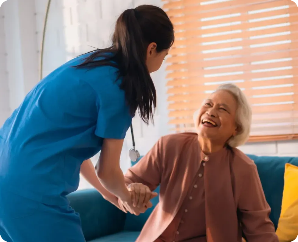 A staff member holding a member's hand at the day center