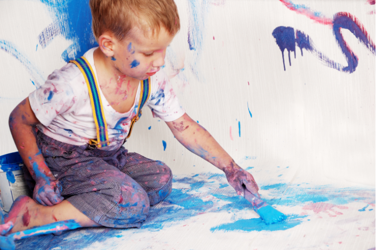 baby covered in blue paint