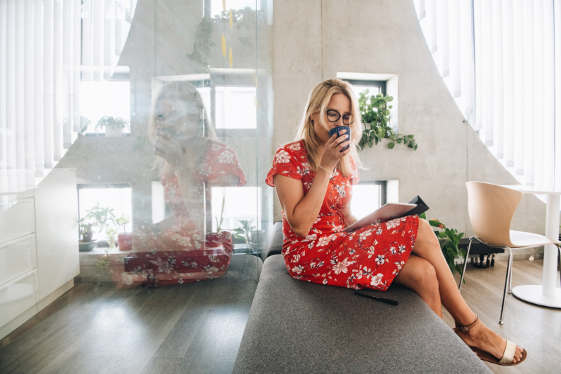 a girl drinking coffee in a modern office
