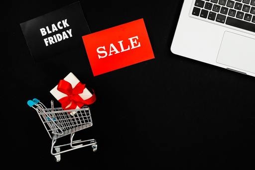 Computer next to black friday sales and marketing offers