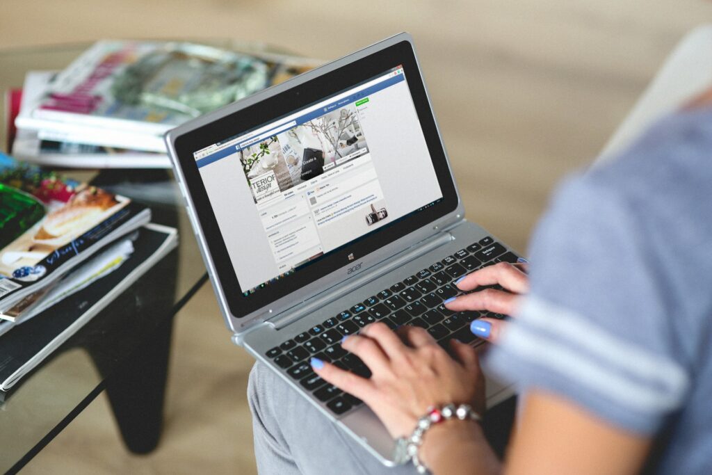 A Person Browsing Facebook on a Laptop