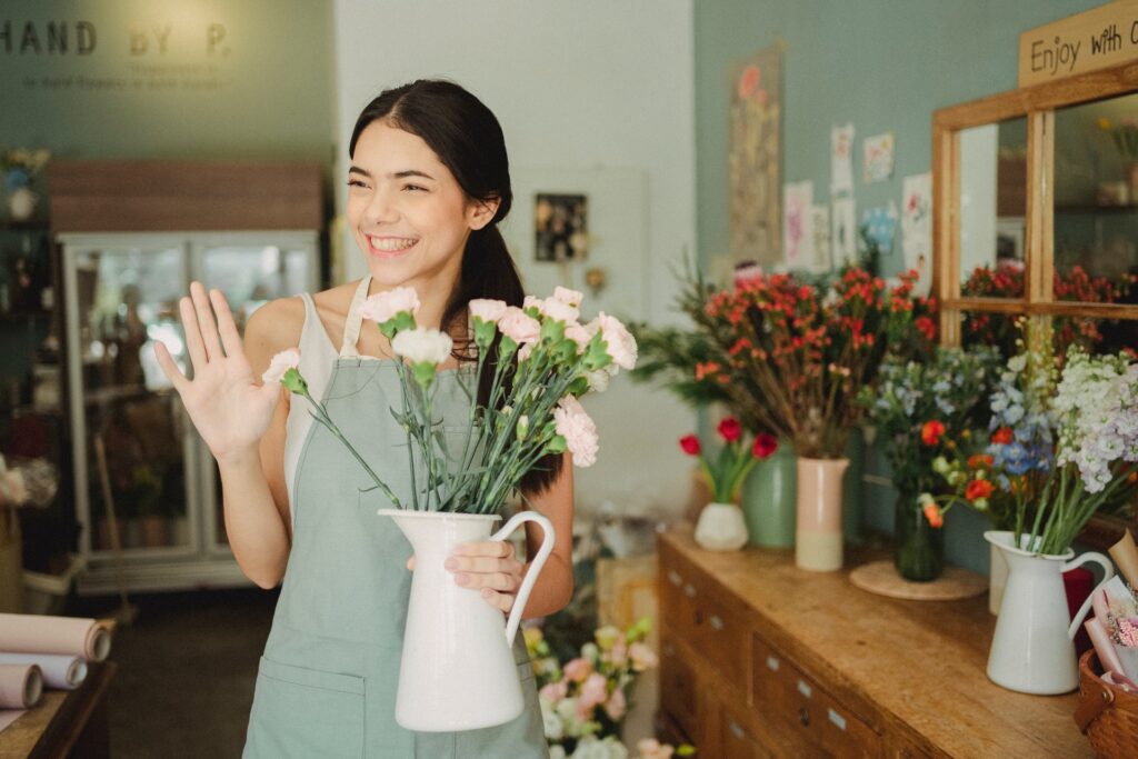 A florist posing in her flower shop for a photo